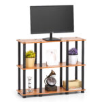 3 tier TV stand in brown wood with open storage shelves holding television and living room decor
