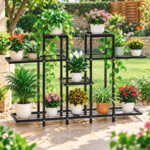 multi tier plant stand in black metal holding multiple potted flowers on garden